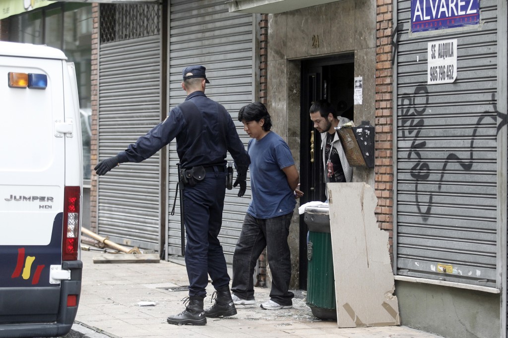 Jorge Cordero cuando fue desalojado de su vivienda por la Policía el pasado mes de junio. Tras él, uno de los activistas del 15-M que se encerró también en el piso. Foto de Mario Rojas.